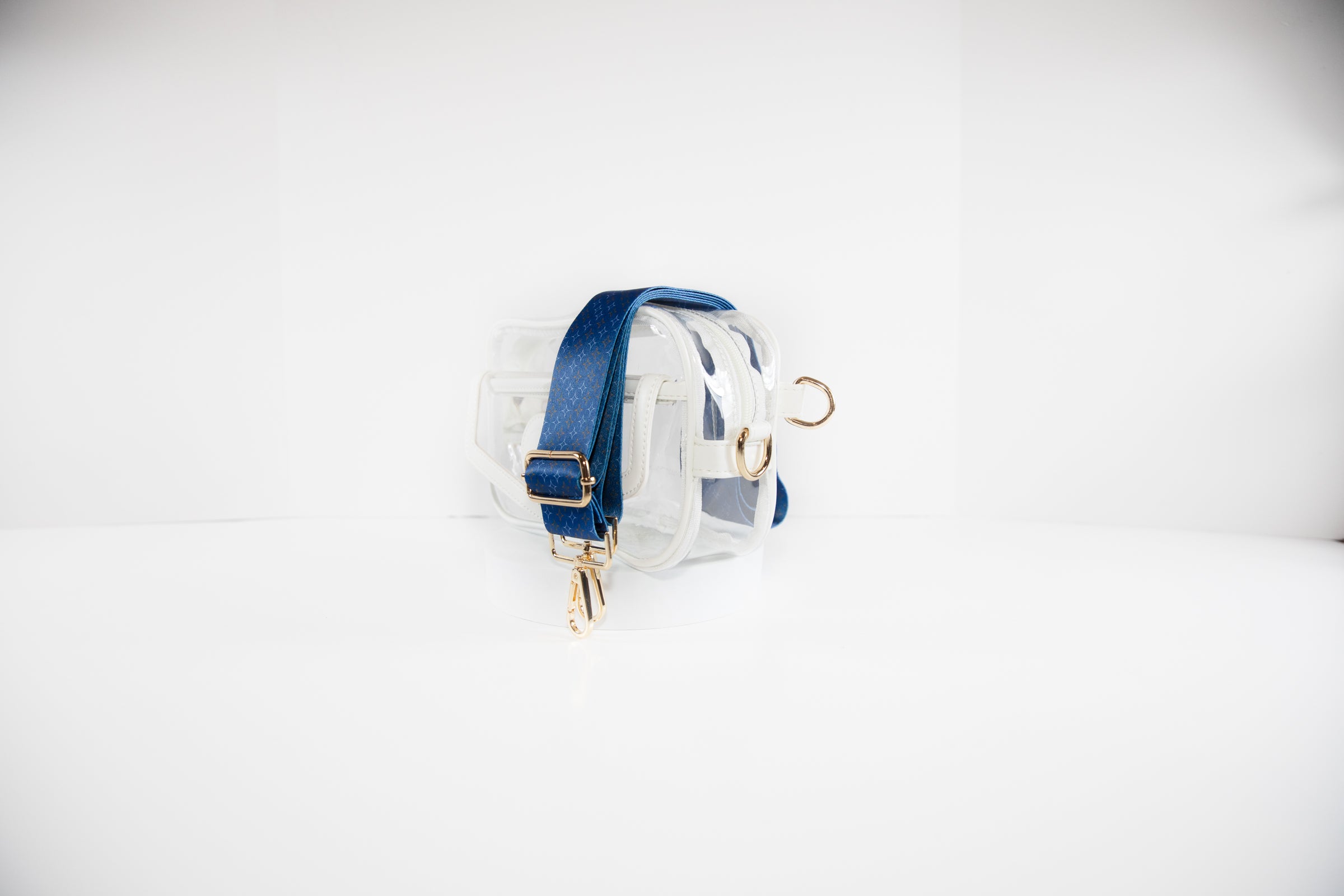 Clear stadium bag in white leather trim shown with a crossbody strap in Houson Astros team colors of orange, white and blue