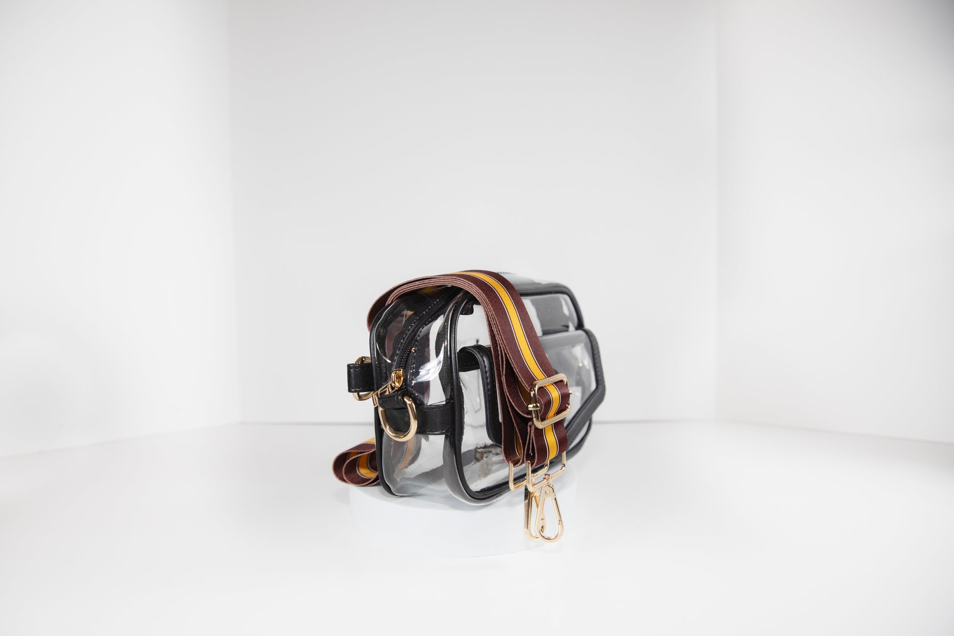 Clear stadium bag in black leather trim, side facing, with a strap in the colors of the Washington Commanders.