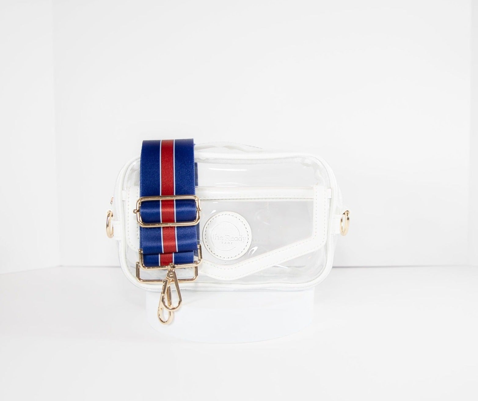 Clear Stadium Bag with white leather trim, front facing, with a crossbody strap in the colors of the New York Giants.