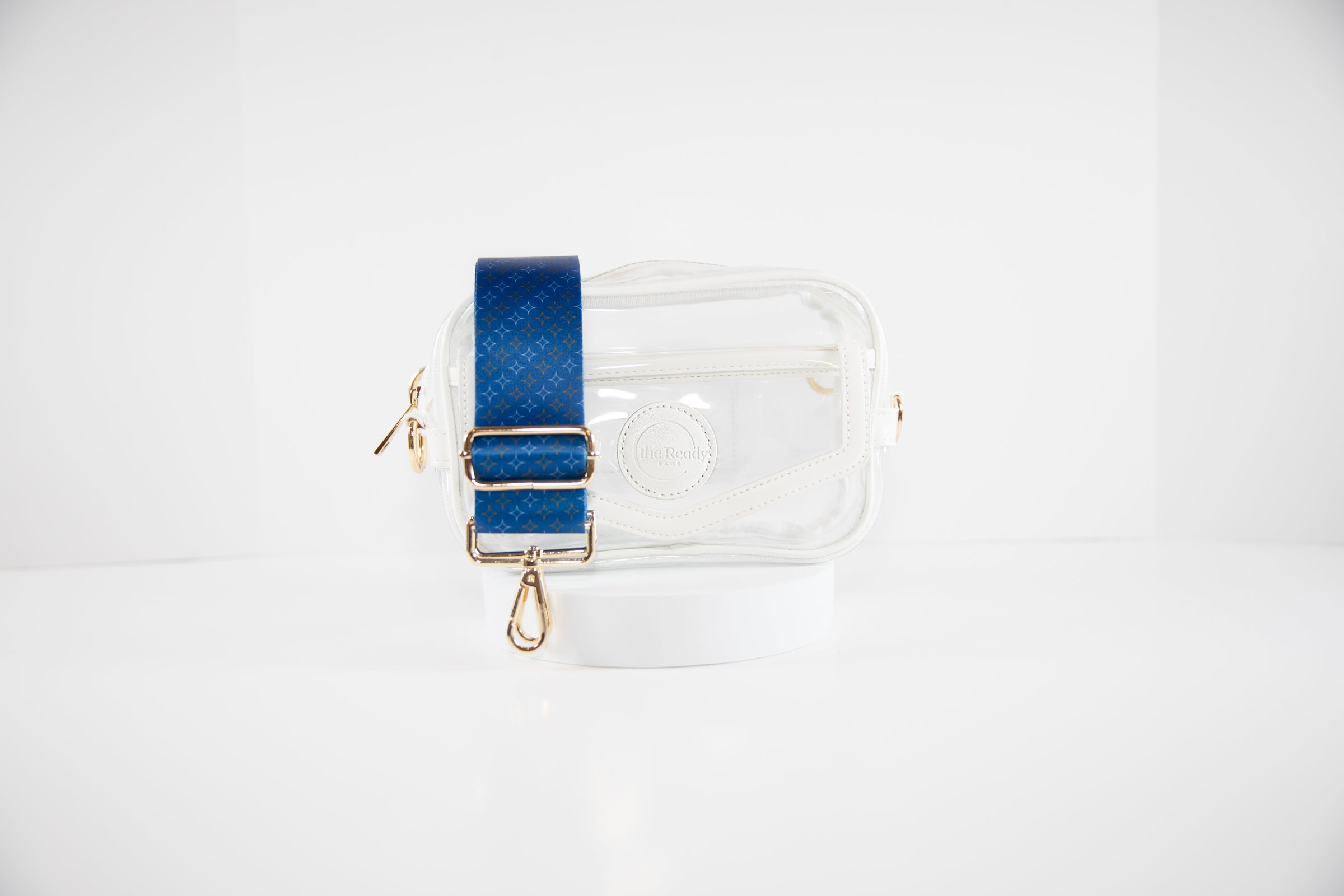 Clear stadium bag in white leather trim shown with crossbody strap in blue, orange and white team colors of the New York Mets