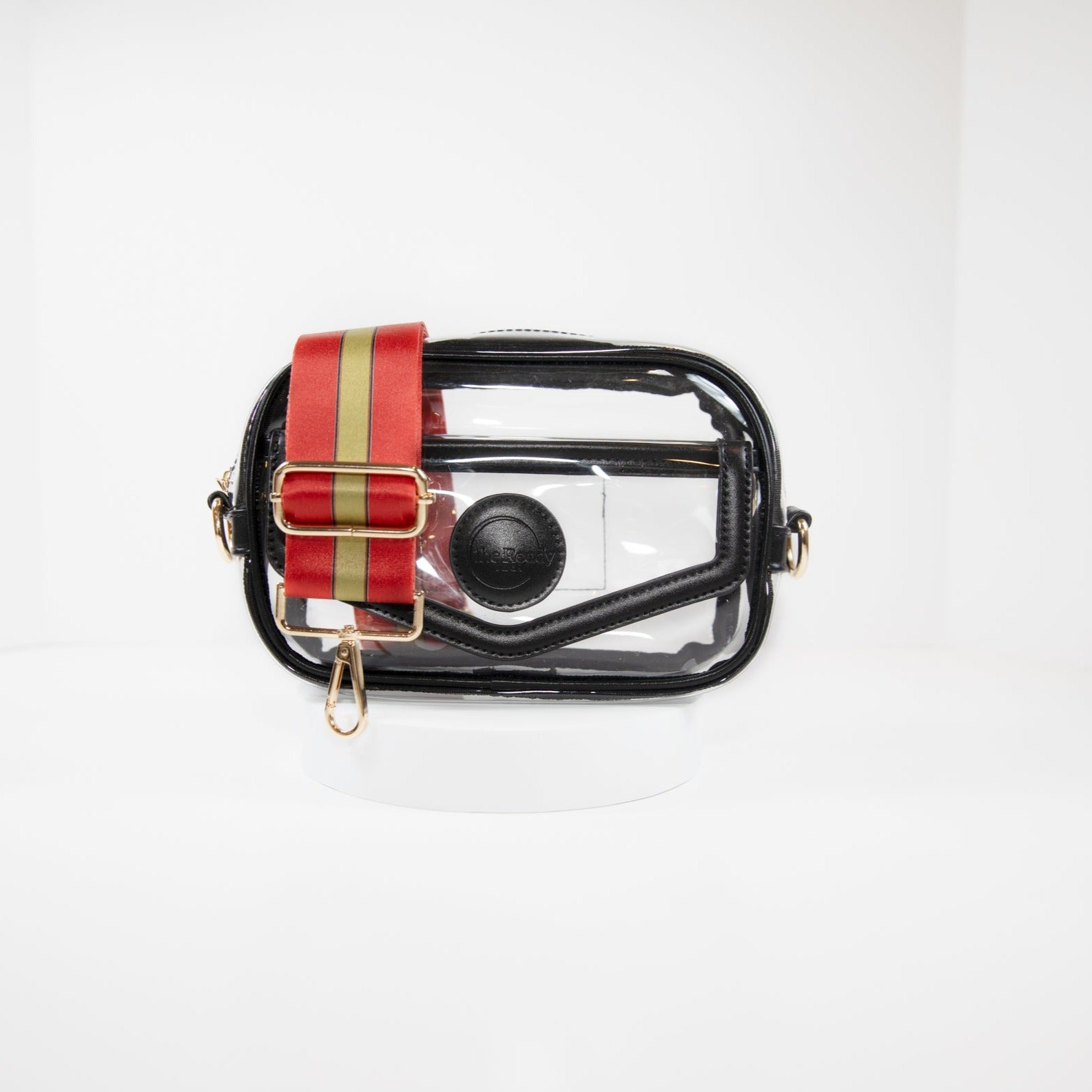 Clear Stadium Bag in black leather trim, front facing, with a strap in San Francisco 49er team colors.