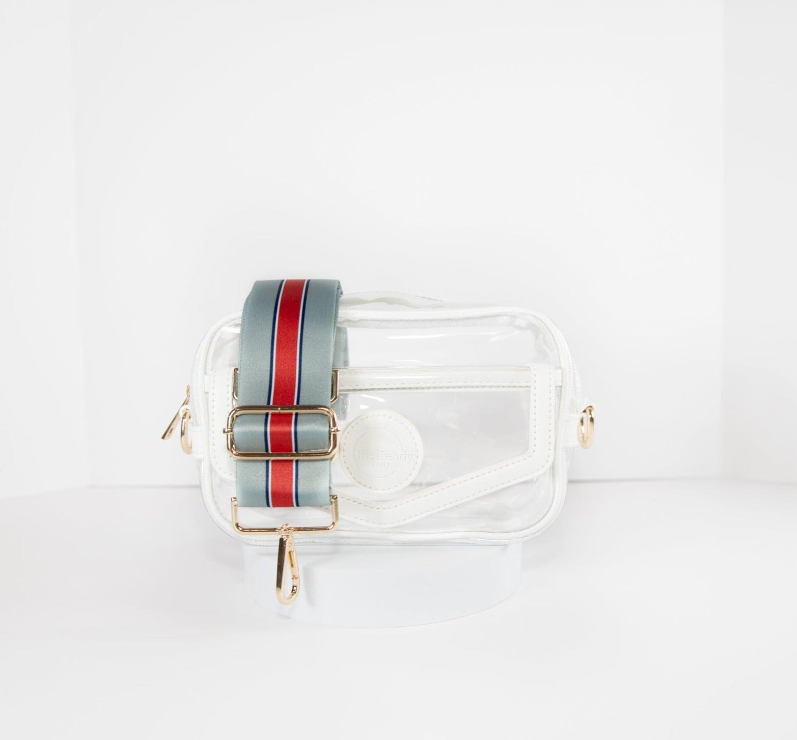 Clear stadium bag in white leather trim, front facing, with the strap in the team colors of the New England Patriots.