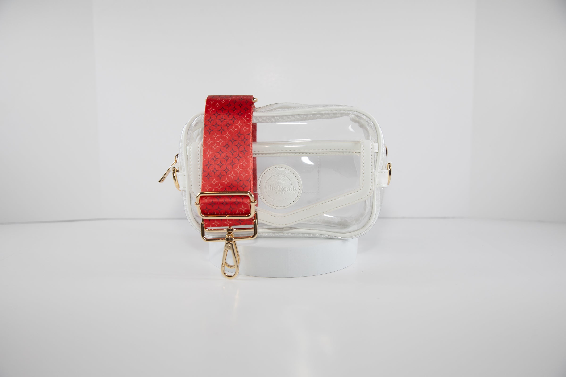 Clear stadium bag with white leather trim, front facing, with an adjustable crossbody strap in Boston Red Sox team colors.