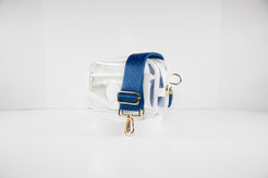 Clear stadium bag with white leather trim shown with a crossbody strap in Kansas City Royals team colors of navy and gold.