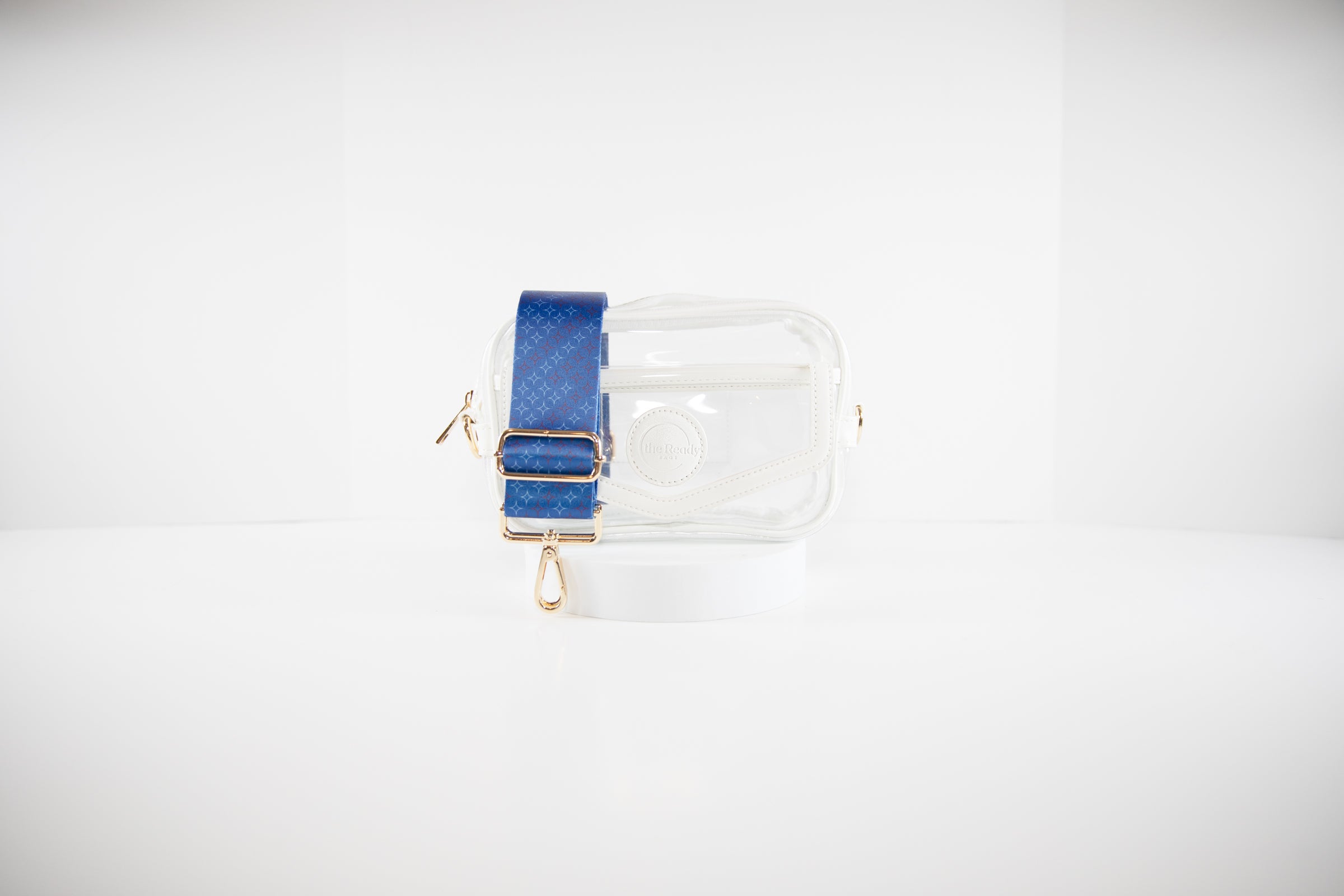 Clear stadium bag in white leather trim with a crossbody strap shown in red, white and blue Texas Rangers team colors