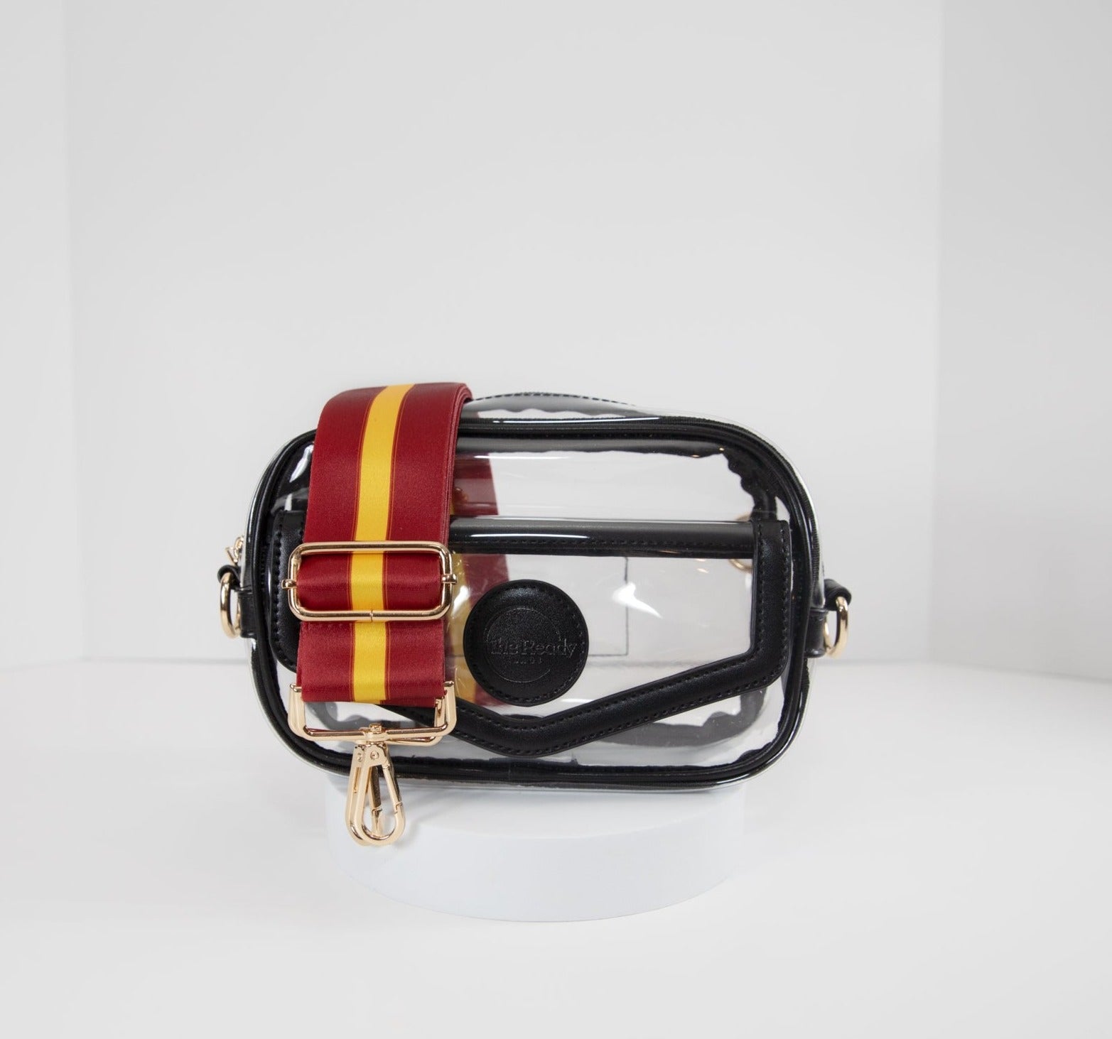 Clear stadium bag in black leather trim, front facing, with a crossbody strap in USC Trojan team colors.