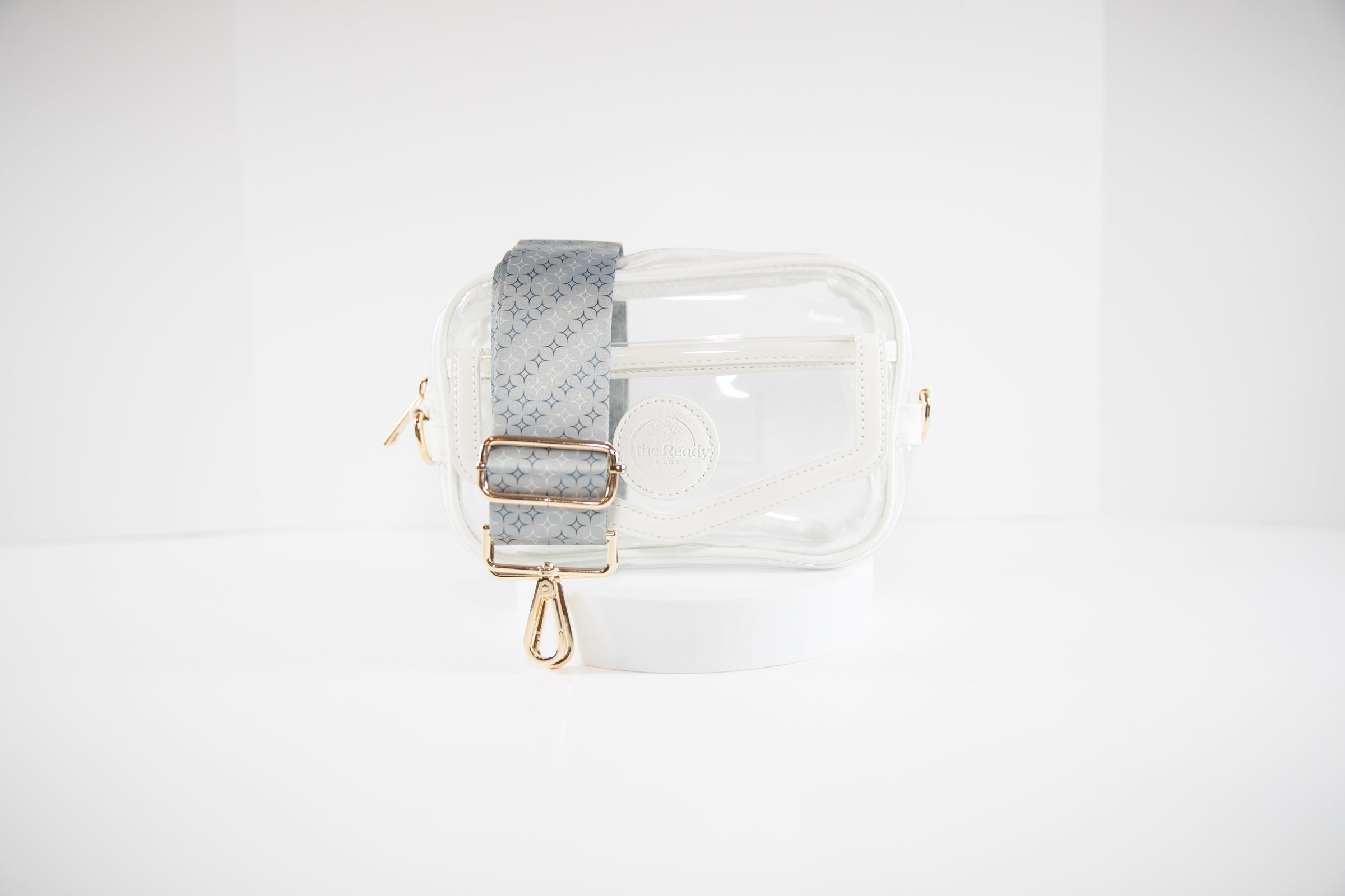 Clear stadium bag in white leather trim shown with a crossbody strap in NY Yankees team colors.