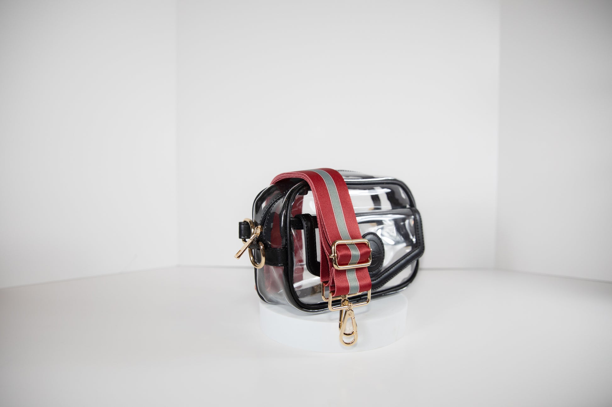 Clear stadium bag with black leather trim, side facing, with a crossbody strap in team colors of Alabama Crimson Tide.