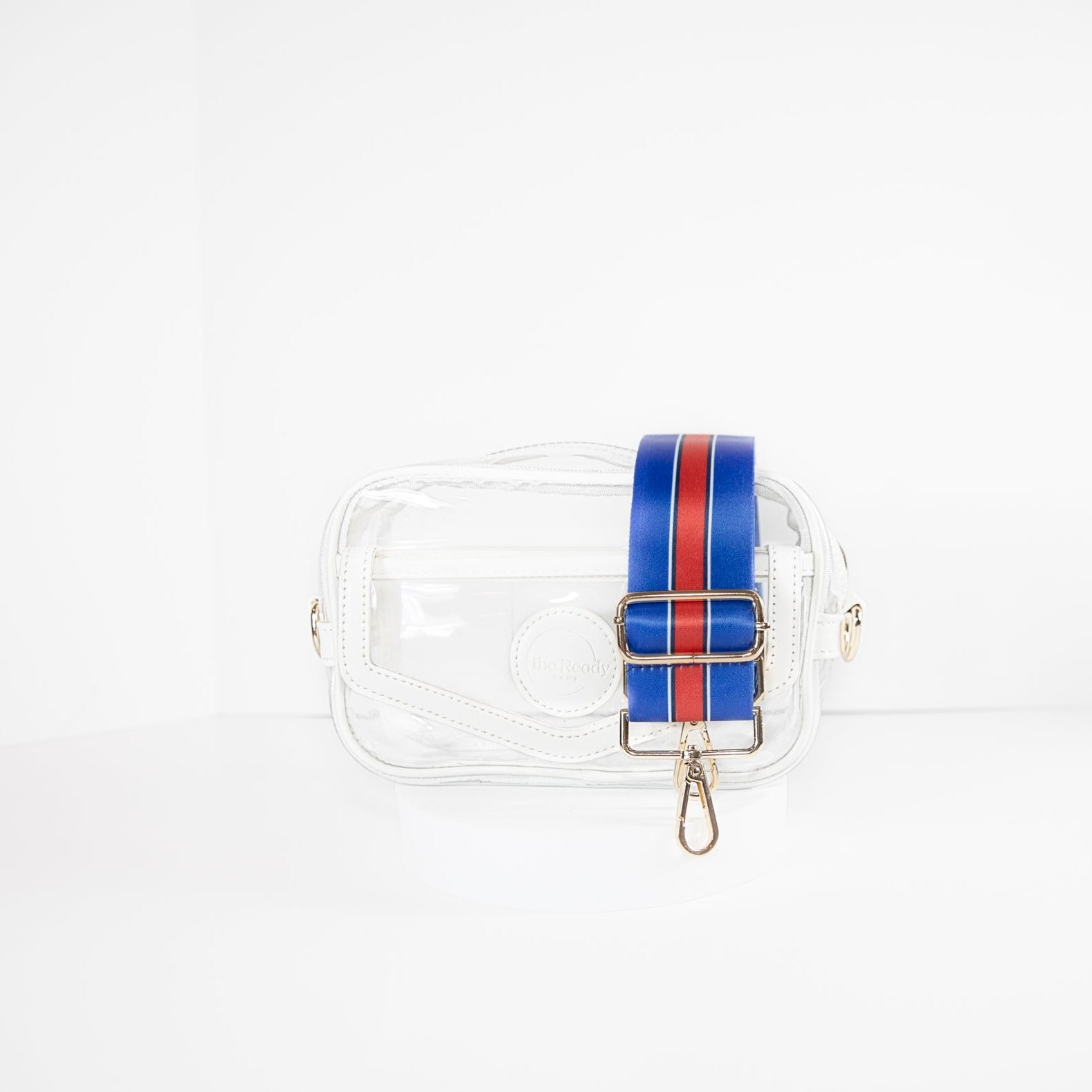 Clear stadium bag with white leather trim, front facing, with a crossbody strap in Buffalo Bills colors.