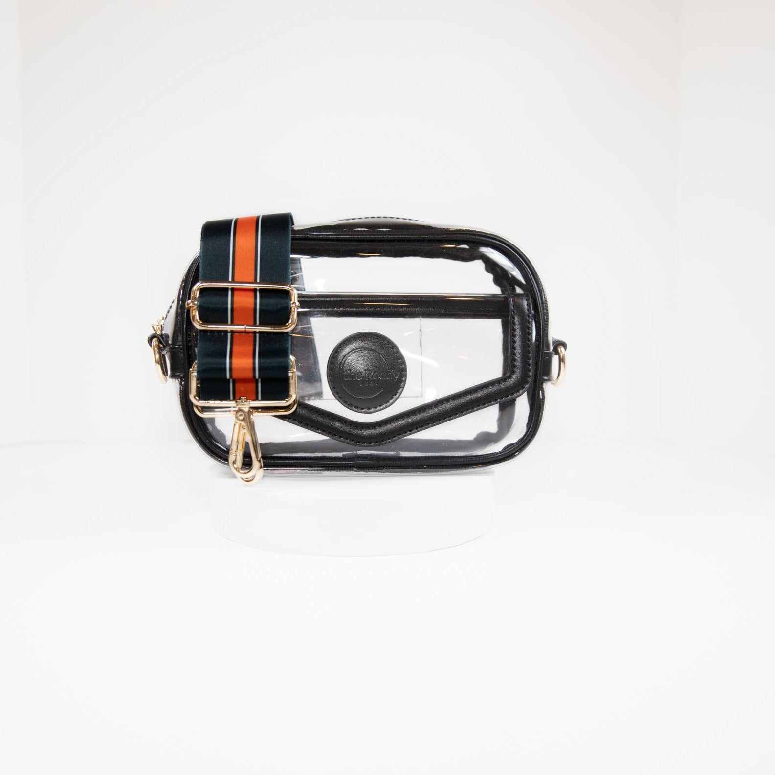 Clear stadium bag with black leather trim, front facing, with a crossbody strap in Chicago Bears team colors.