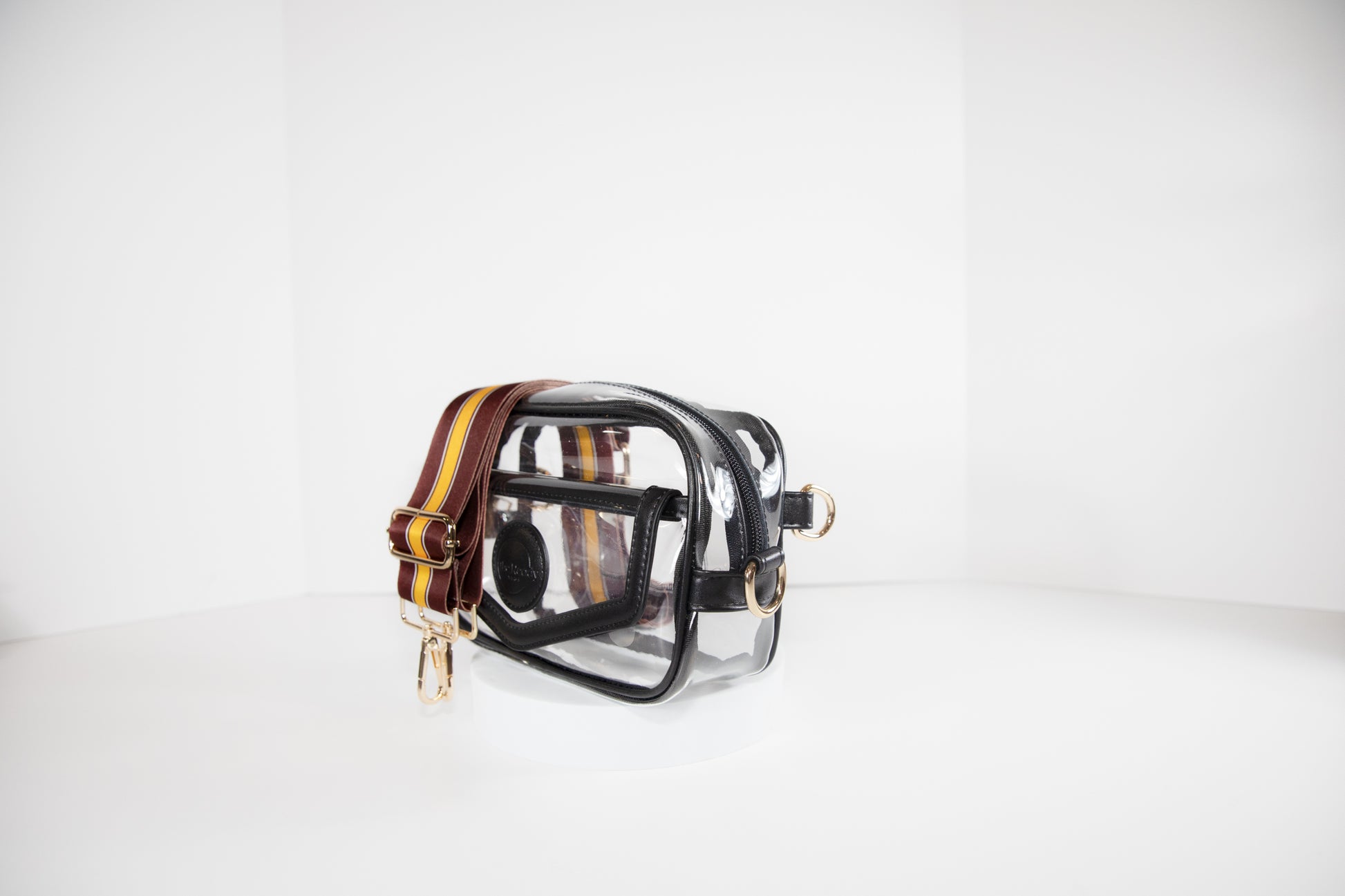 Clear stadium bag in black leather trim, side facing, with a strap in the colors of the Washington Commanders.