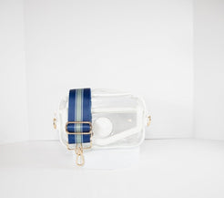 Clear stadium bag in white leather trim, front facing, with a crossbody strap in the team colors of the Dallas Cowboys.