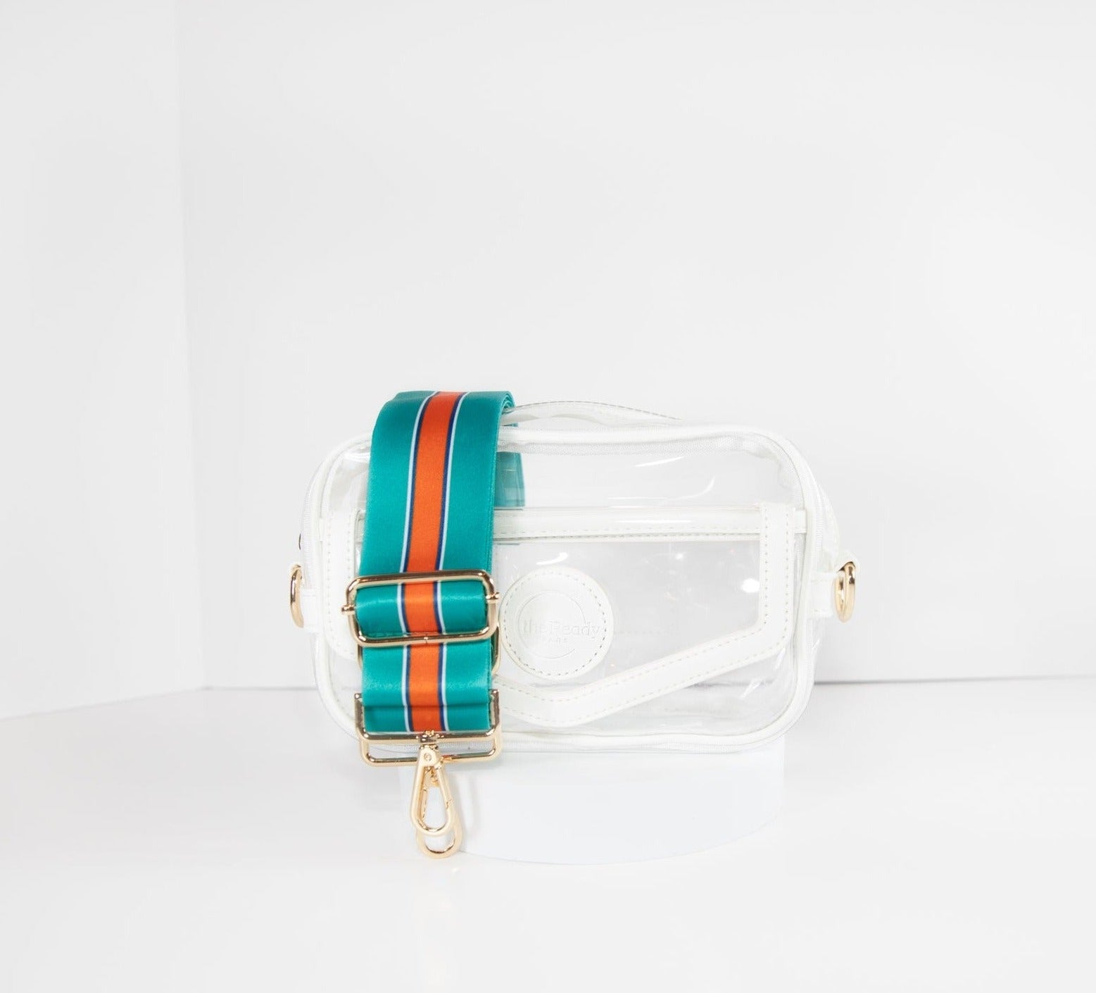 Clear Stadium bag in white leather trim, front facing, with a crossbody strap in Miami Dolphins colors.