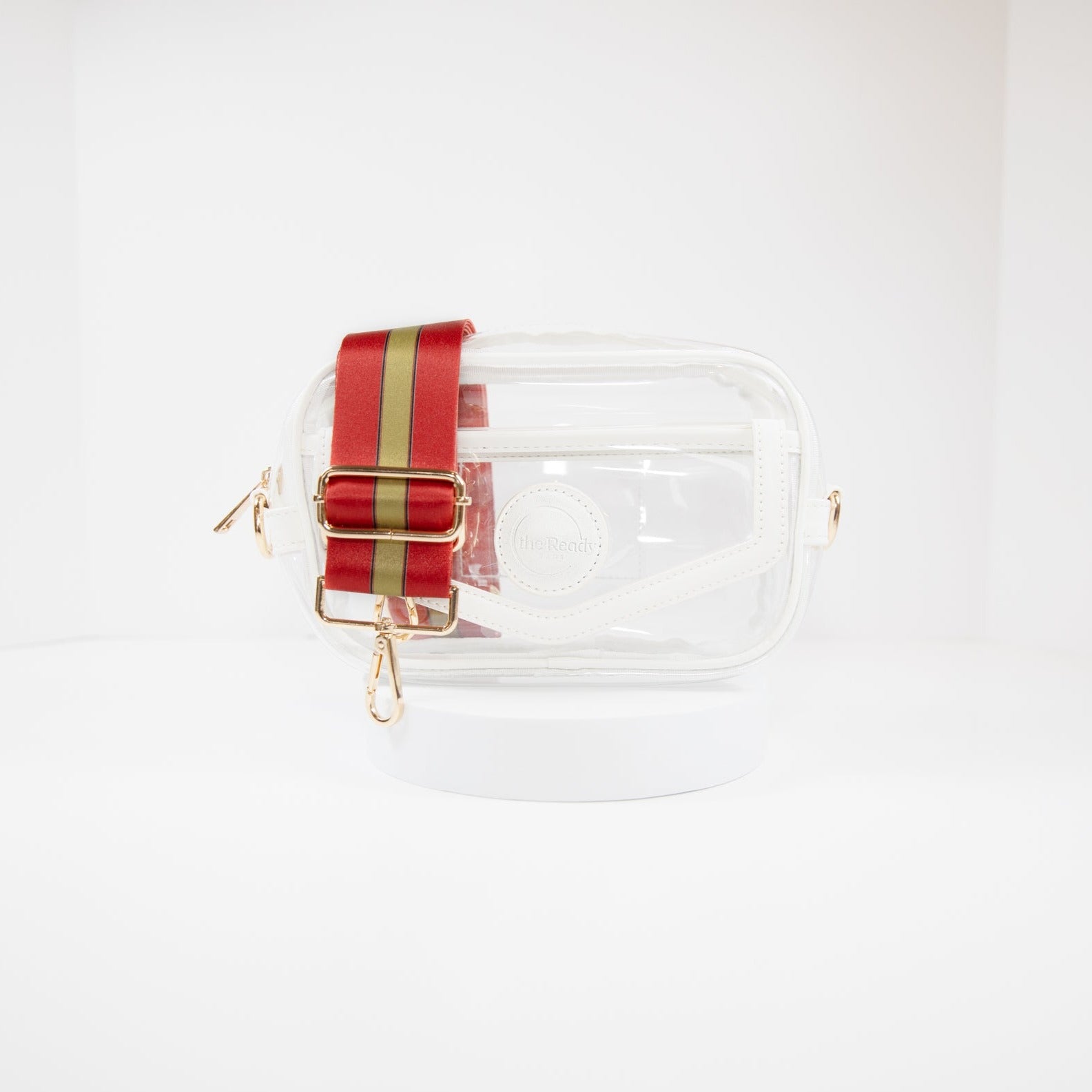 Clear Stadium Bag in white leather trim, front facing, with a crossbody strap in San Francisco 49er team colors.