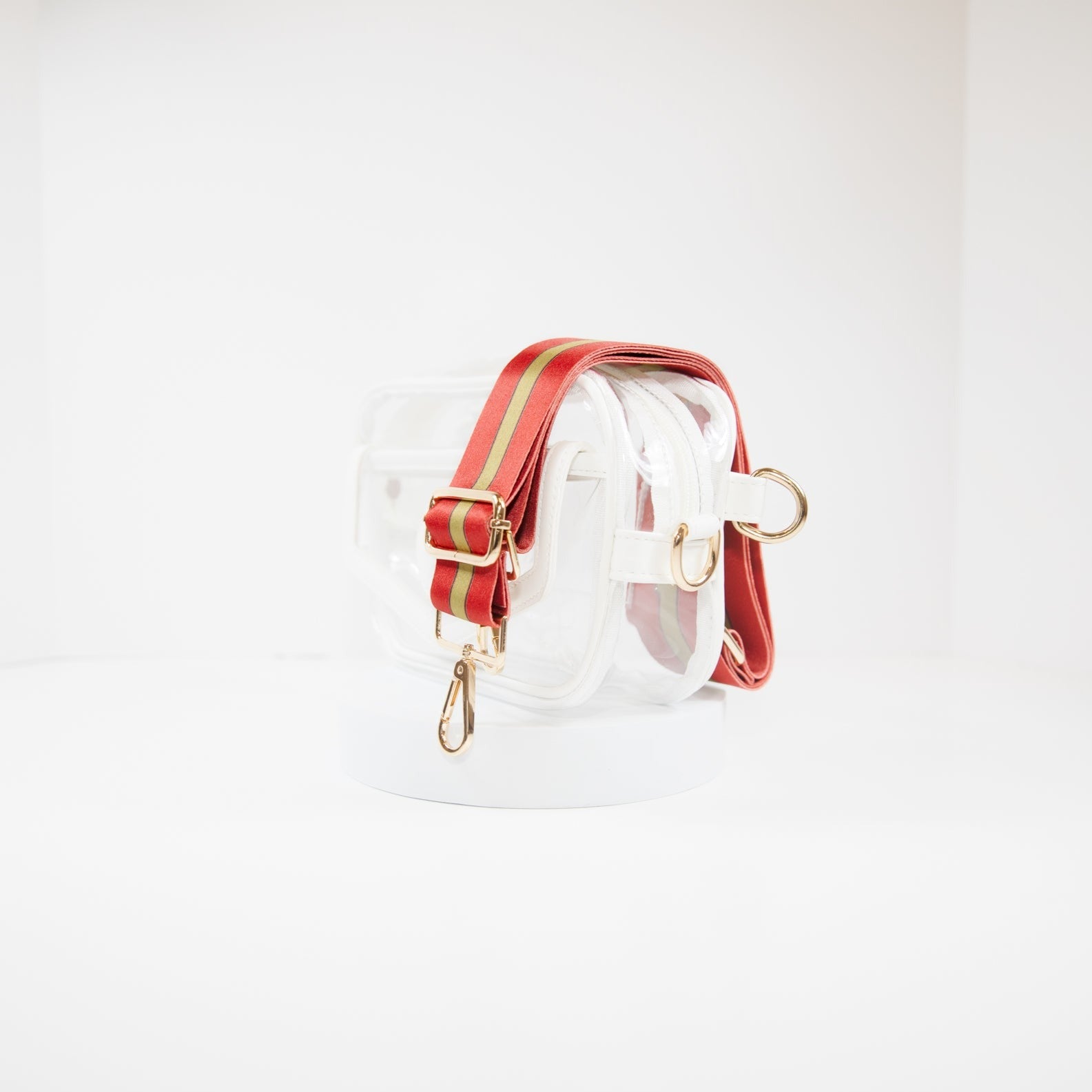 Clear Stadium Bag in white leather trim, side facing, with a crossbody strap in San Francisco 49er team colors.