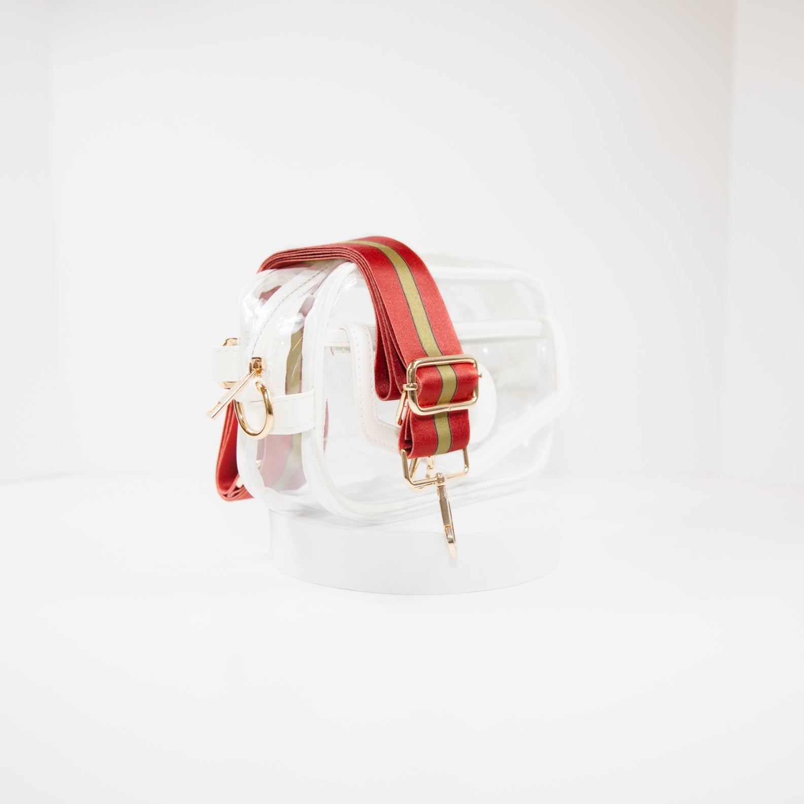 Clear Stadium Bag in white leather trim, side facing, with a crossbody strap in San Francisco 49er team colors.