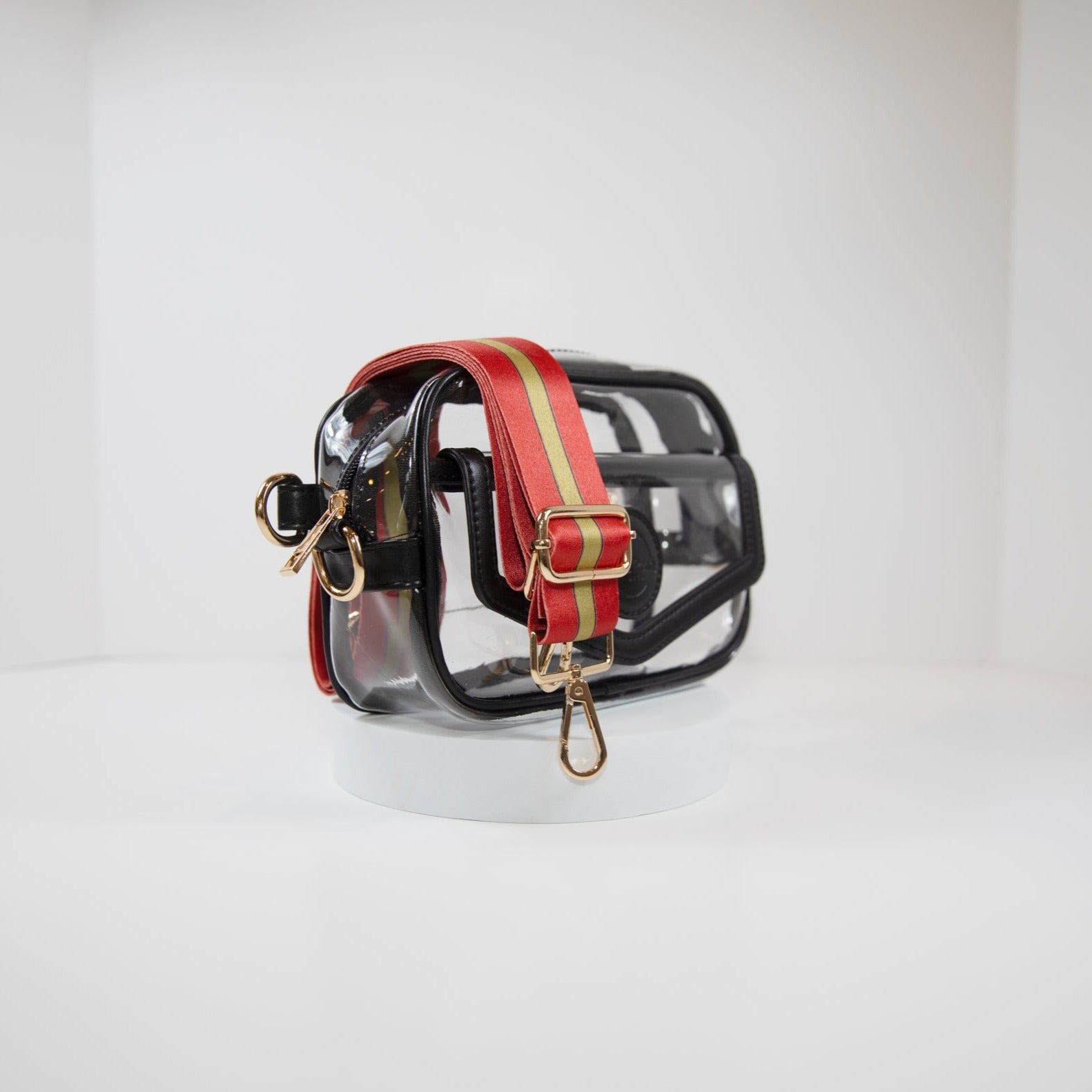 Clear Stadium Bag in black leather trim, side facing, with a crossbody strap in San Francisco 49er team colors.