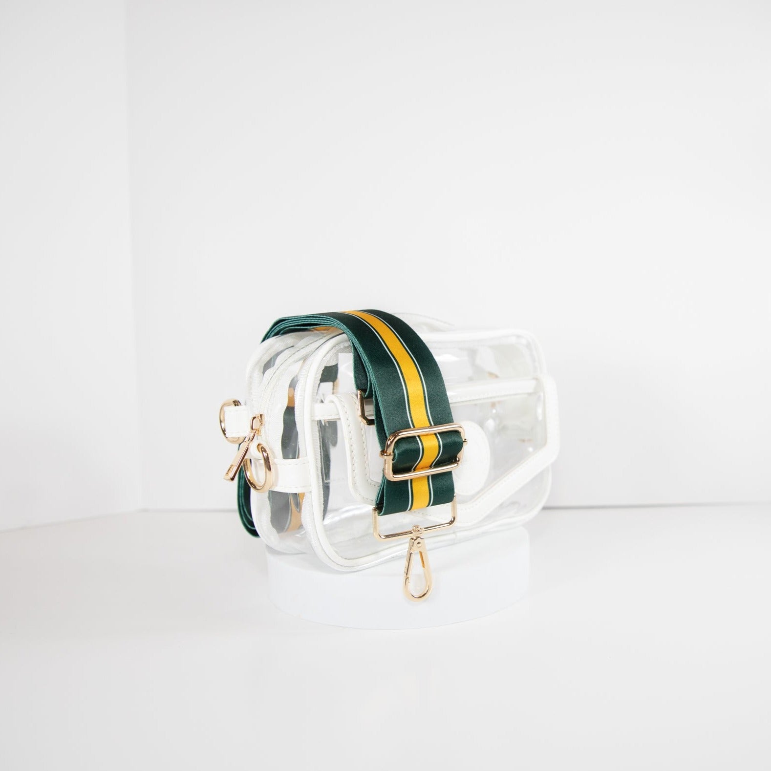 Clear Stadium Bag in white leather trim, side facing, with a strap in the team colors of the Green Bay Packers.
