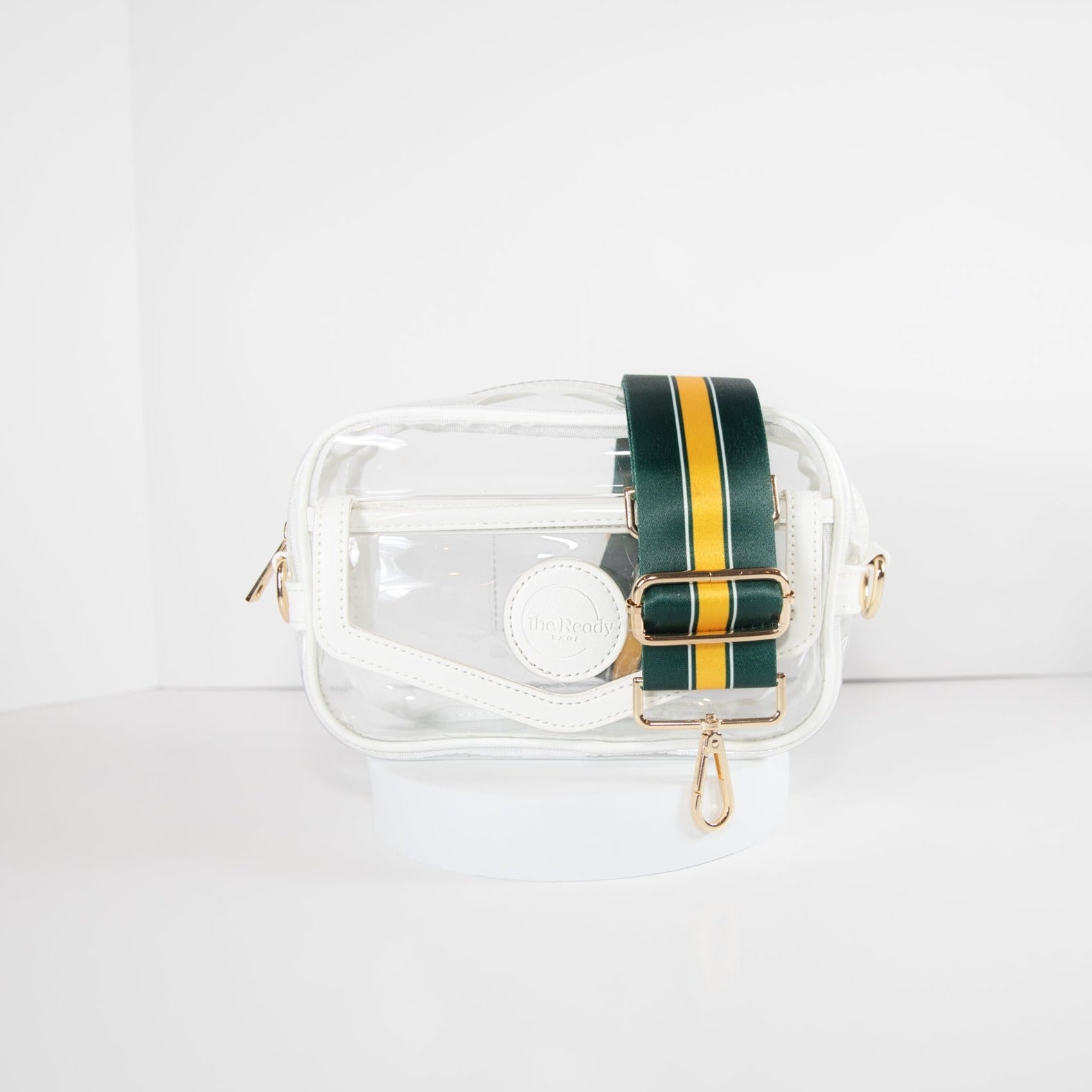 Clear Stadium Bag in white leather trim, front facing, with a strap in the team colors of the Green Bay Packers.