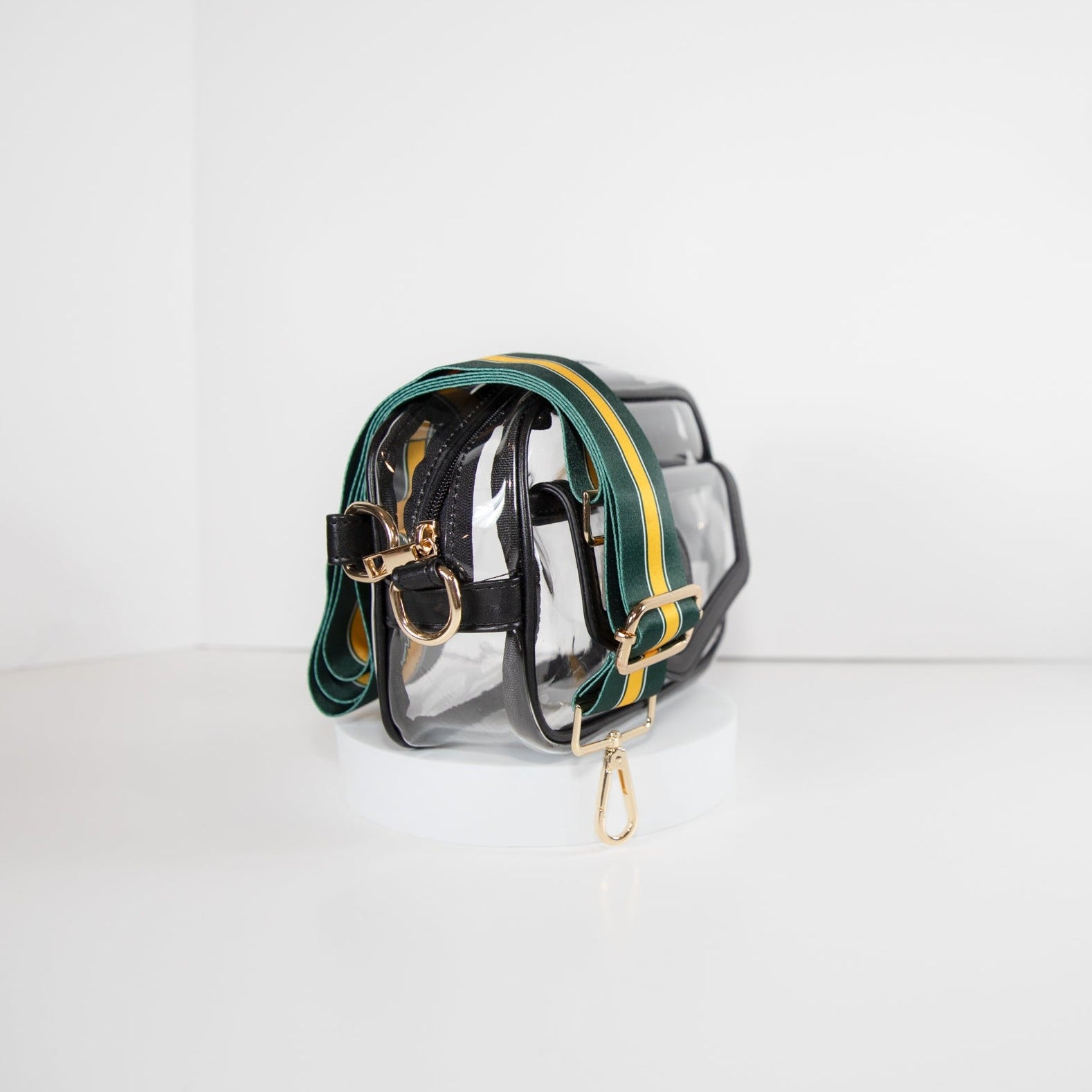 Clear Stadium Bag in black leather trim, side facing, with a strap in the team colors of the Green Bay Packers.