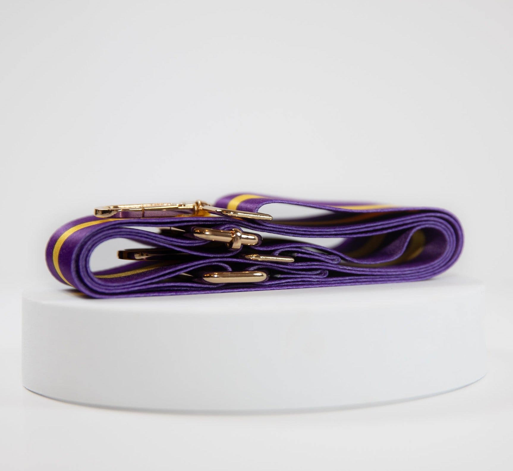 Elegant crossbody strap shown in LSU Tigers team colors of purple and gold.