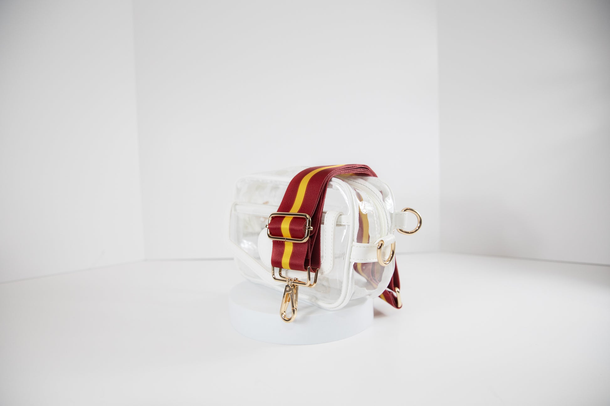 Clear stadium bag in white leather trim, side facing, with a crossbody strap in USC Trojan team colors.
